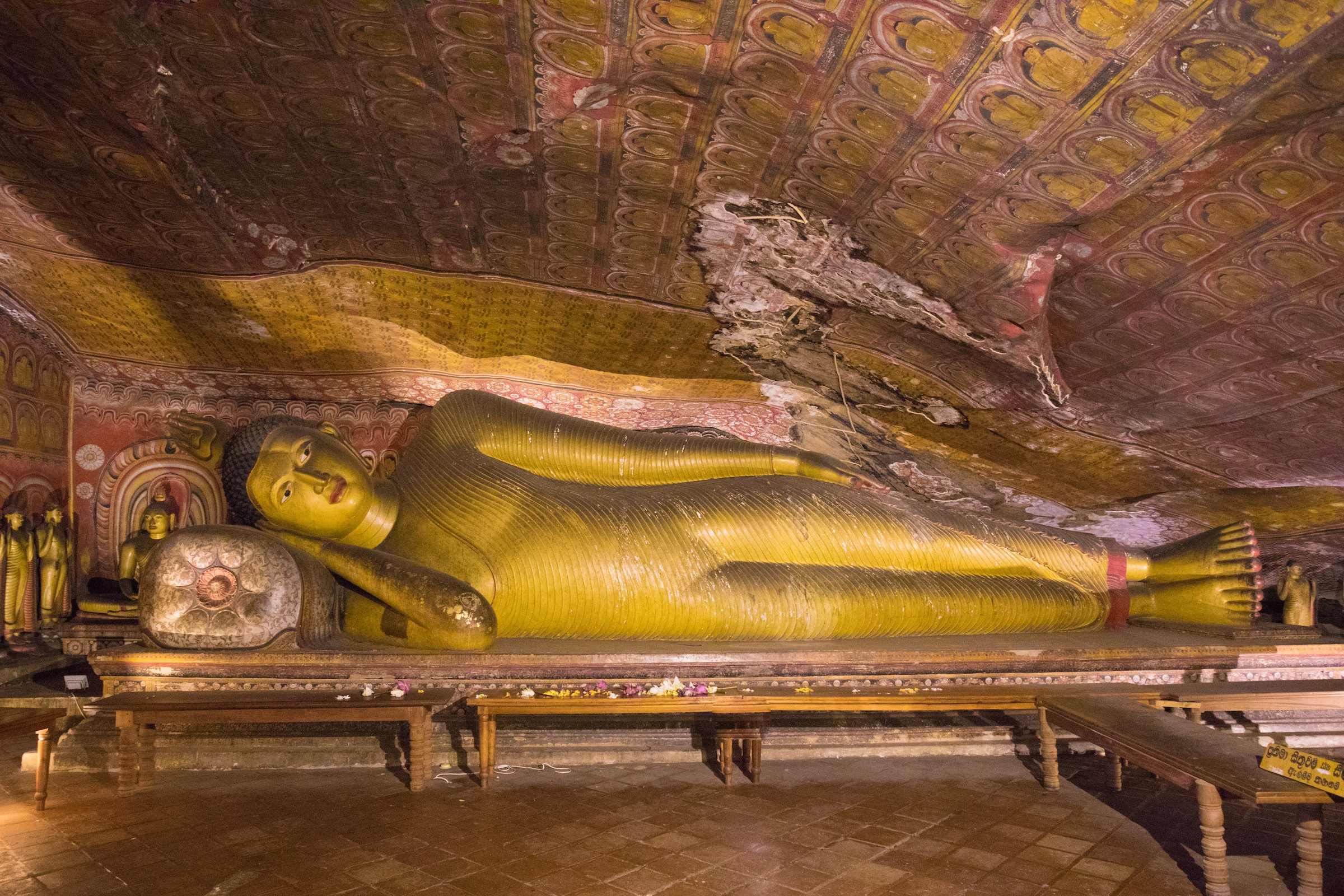 The statue of a reclining Buddha inside a cave temple at Dambulla