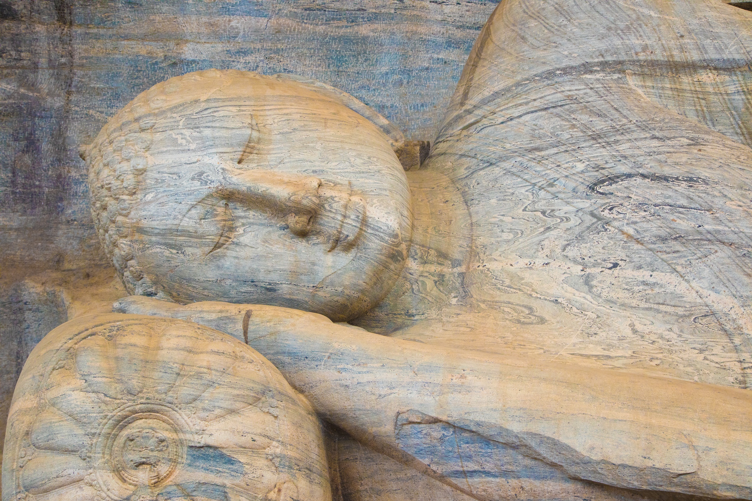 The face of a reclining Buddha inside Polunnaruwa