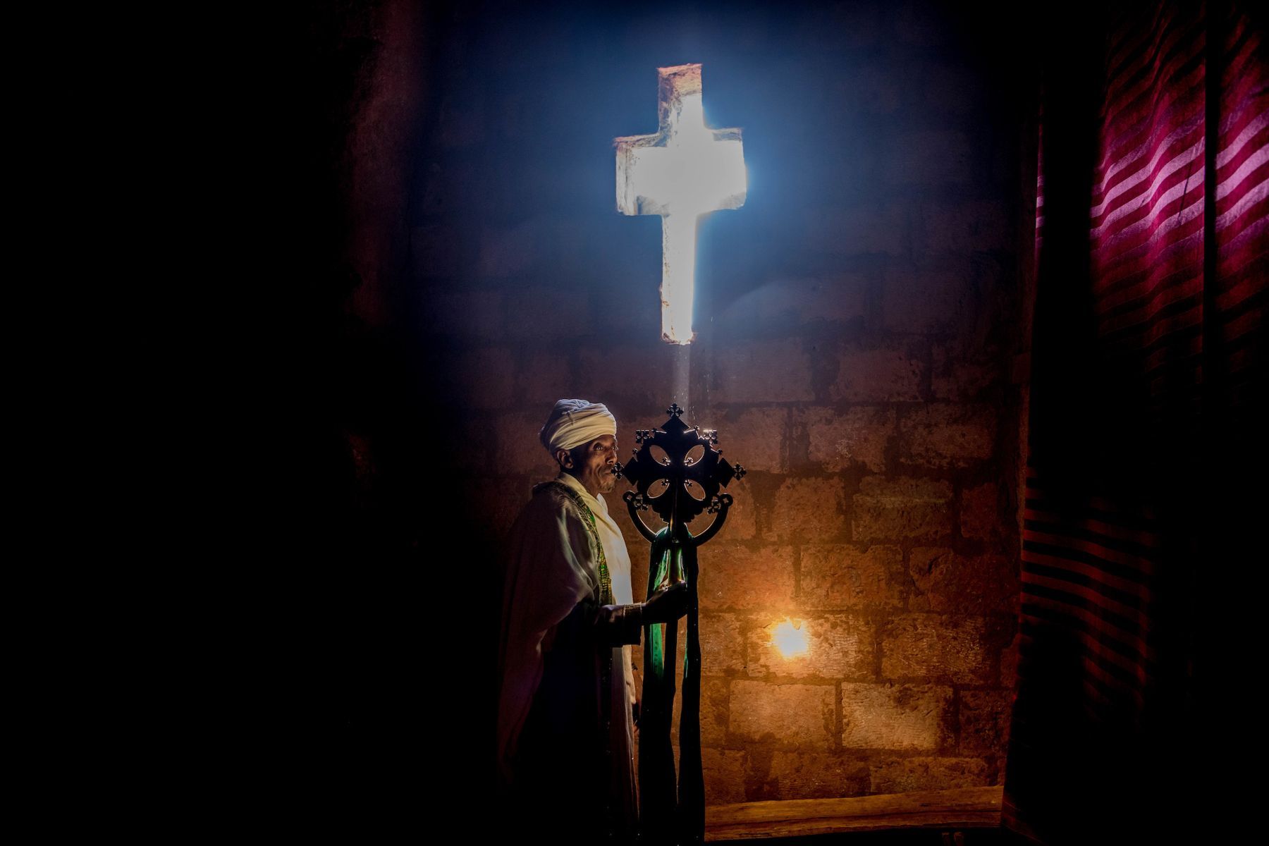 A priest holding his crucifix at Lalibela in Ethiopia