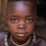 Portrait of a young Himba boy on our photography tour of Namibia