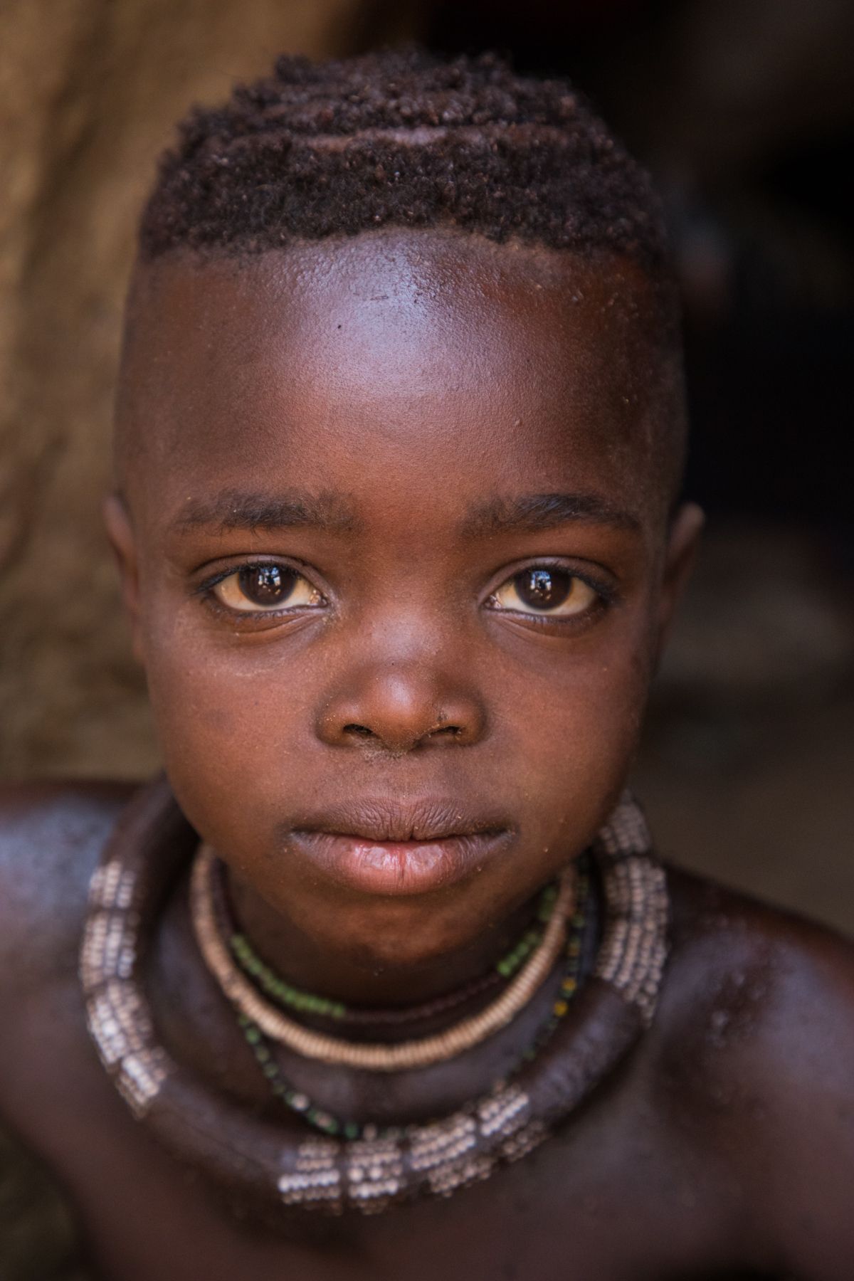 Portrait of a young Himba boy on our photography tour of Namibia