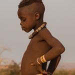 Young Himba boy in contemplation