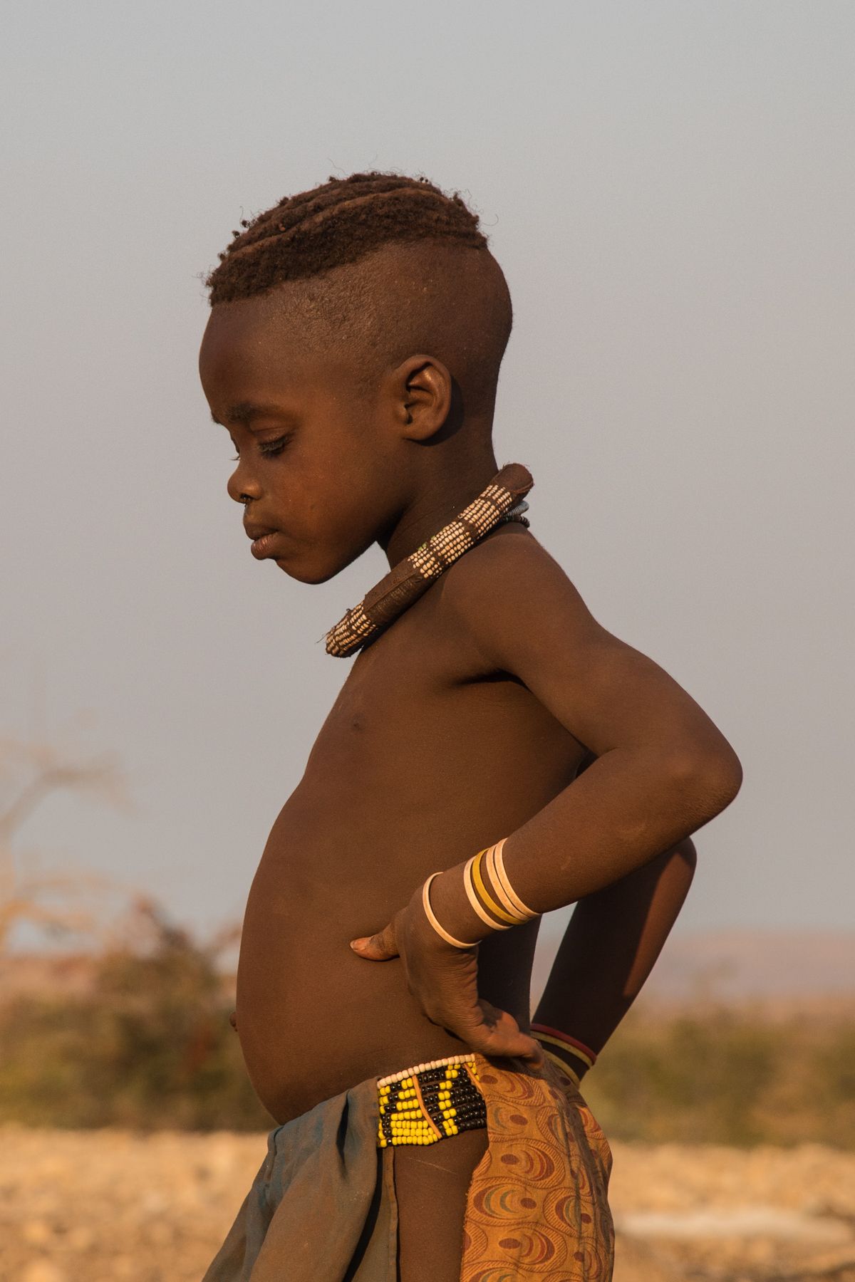 Young Himba boy in contemplation
