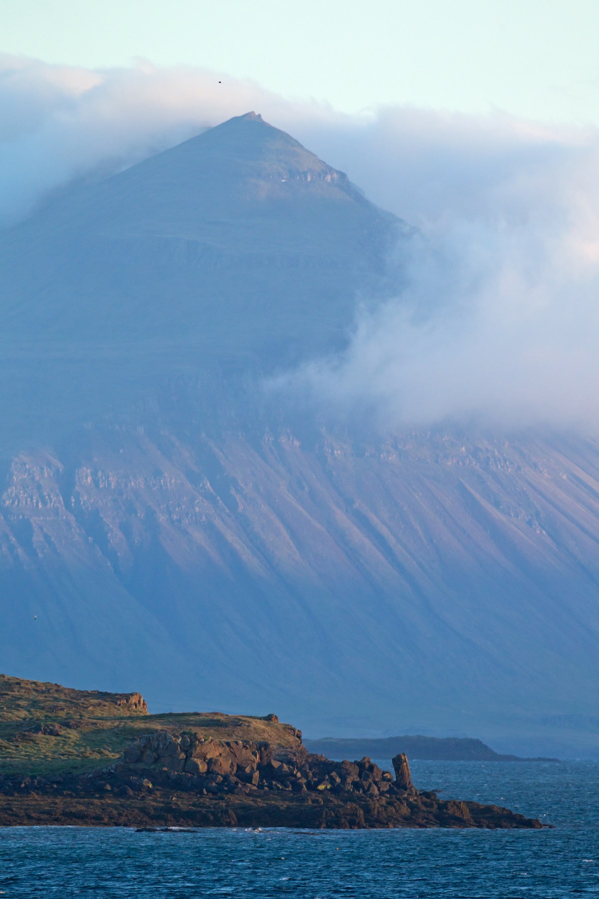 A volcanic peak towers high over Stykkisholmur in northwestern Iceland