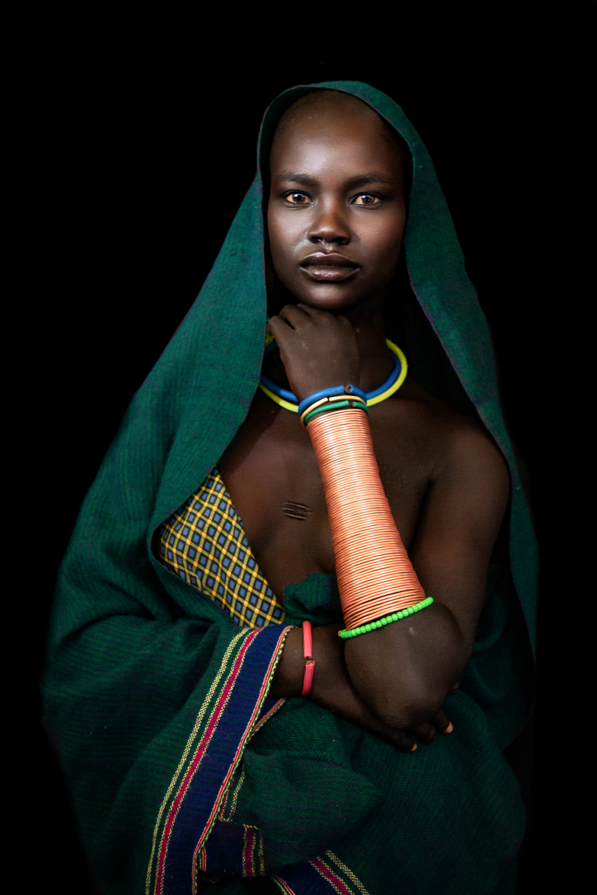 Portrait of a young Suri woman by Inger Vandyke of Wild Images photo tours