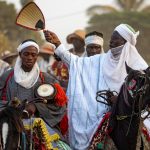 The leader of a Batonu troupe orders his horsemen to start a ceremony during our Benin photo tour