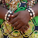 Cowrie jewellery adorns a voodoo follower after she emerges from a forest initiation rite