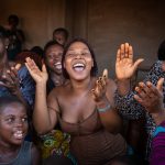 Local women sing to appease the ancestors of Egungun dancers in their village