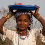 A beautiful Fulani girl selling produce on the roadside of northern Benin