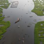 Flying a drone over Lake Nokwe on our Benin photo tour