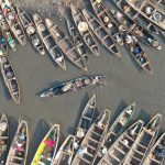 Colourful pirogues dock in Cotonou after Tofinu fishermen bring fish to the local market