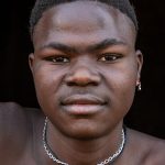 The beautiful Otamari scarification on the face of Jerome, a young Otamari initiate on our Benin photography tour