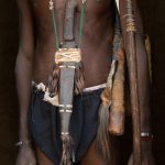 A dagger hangs in a sheath from the neck of an Otamari Fetish Chief
