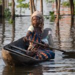 Tofinu girl paddling her canoe in the canals of Ganvie on the Wild Images photography tour of Benin