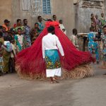 Each time Zangbetos are released to twirl into the night they are led by a guard into the streets