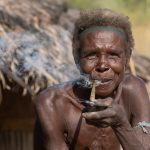 Portrait of an elderly Laarim woman smoking Ijoo, a local tobacco