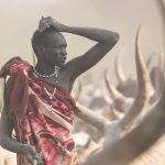 Portrait of Guli taking a moment to contemplate the whereabouts of his cows in a Mundari cattle camp