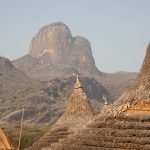 The pretty rooftops of Laarim villages emulate the soaring peaks of the Kimotong Mountains in the background