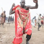 Malik stops to pose during the Yanguera, a traditional dance of the Mundari people