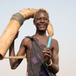 Portrait of Mochi holding his traditional 'Tung' or musical horn made from the cowhorns of Mundari cattle