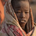 Portrait of a young Mundari boy at sunrise