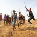 A group of Toposa men performing an impromptu Nyakwomoa, the dance of men normally reserved for Toposa weddings