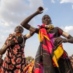 Athletic poses of dancing Toposa women during a ceremony of Meriye