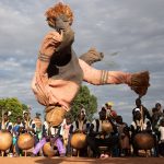 A Boloye dancer somersaults during the Panther Dance