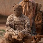 Boloye dancers wait for the performance of the panther dance on our photo tour of Ivory Coast