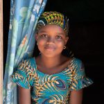 A beautiful Fulani girl in the door of her home