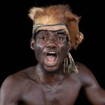 A Gla Guardian yells out a command to a masked dancer on our Ivory Coast photo tour