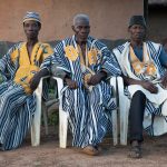 Godufu elders oversee the stilt dance in their village on our photo tour of Ivory Coast