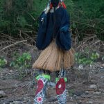 A Stilt Dancer emerges from the sacred forest of Godufu