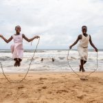 Children use kelp as skipping ropes at N'Zima fishing village of Grand Bassam