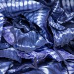 A collection of indigo tie-dyed cloths at a textile plant in Abidjan