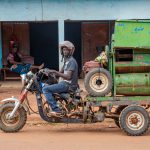 Portrait of a man with his rice machine on the streets of Boundiali, Ivory Coast