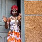 Portrait of a Komian in the door of her home at Aniassué, Ivory Coast