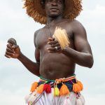 A young man dances the circle of N'Goro Fire Dance in Senufo culture