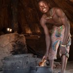 A young Niofoin boy prepares a meal from the morning sacrifice