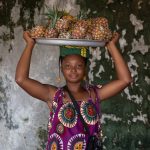 Portrait of a girl selling pineapples on our Ivory Coast photo tour