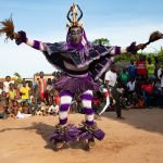 A Zaouli dancer leaps into the air during our Ivory Coast photo tour
