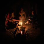 Enjoying dinner around the fire with a Waorani family in the Amazon rainforest