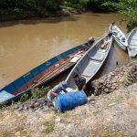 Boarding canoes to travel into the Amazon