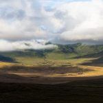 Dappled light shines over a distant Maasai boma near Ngorongoro Crater