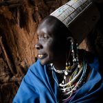 Portrait of a beautiful Maasai woman at the entrance to her home