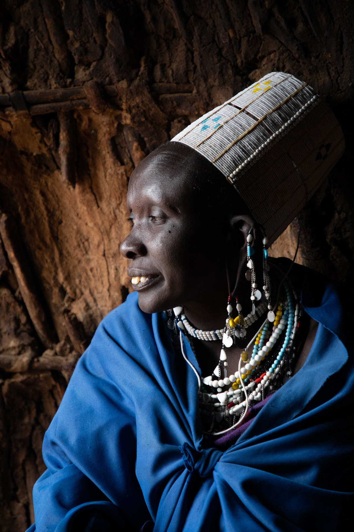 Portrait of a beautiful Maasai woman at the entrance to her home