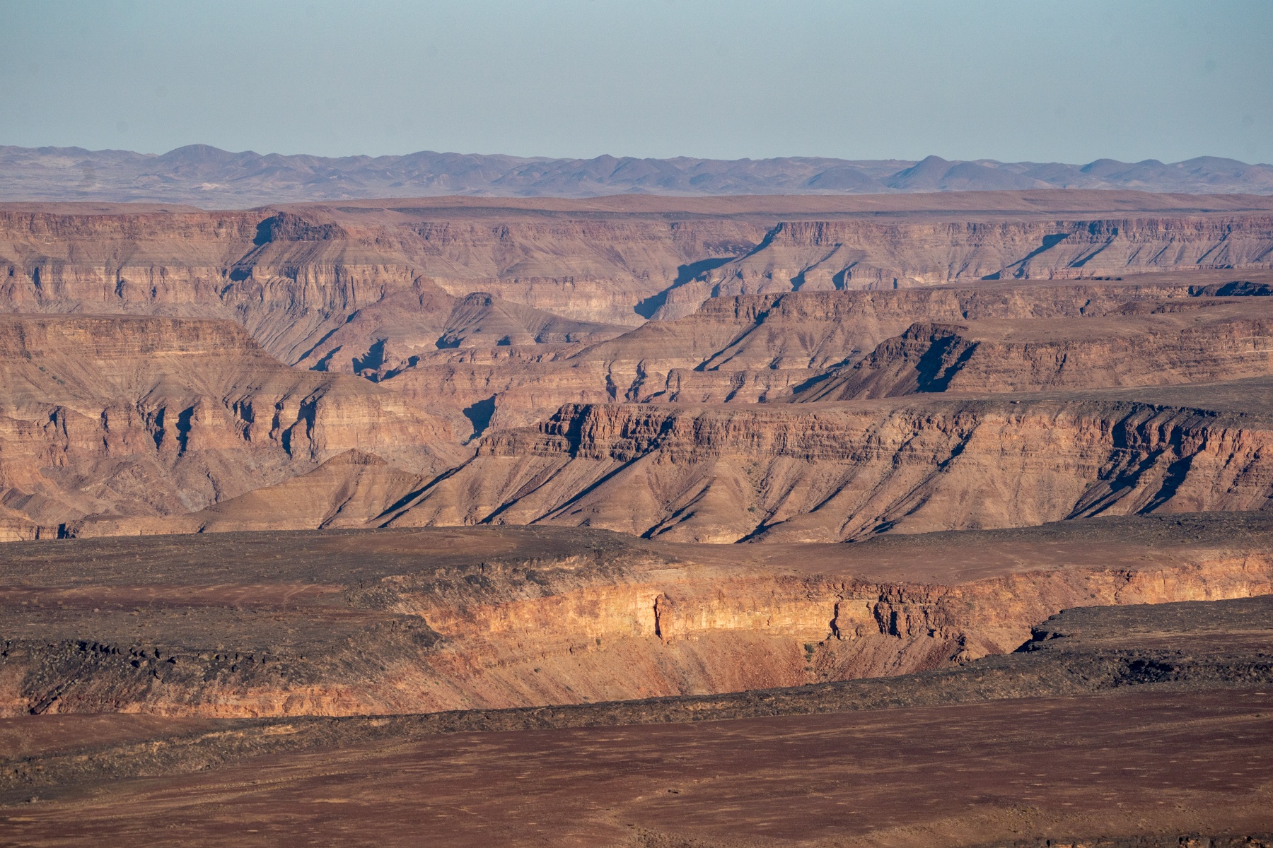 The multilayered cliffs surrounding Fish River Canyon, the second largest canyon on earth after the Grand Canyon