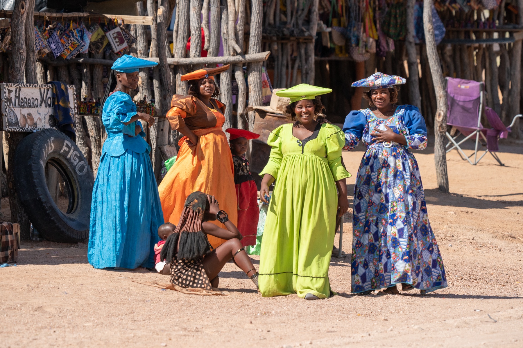 Herero women giggling next to their roadside stalls in Damaraland