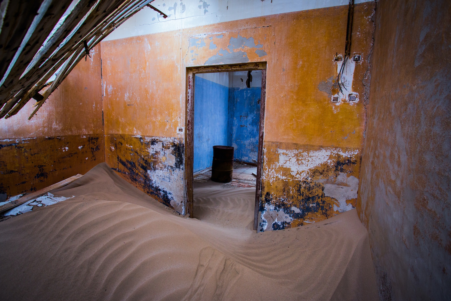 Dunes invade a room inside the ruined mining town of Kolmanskop in Namibia