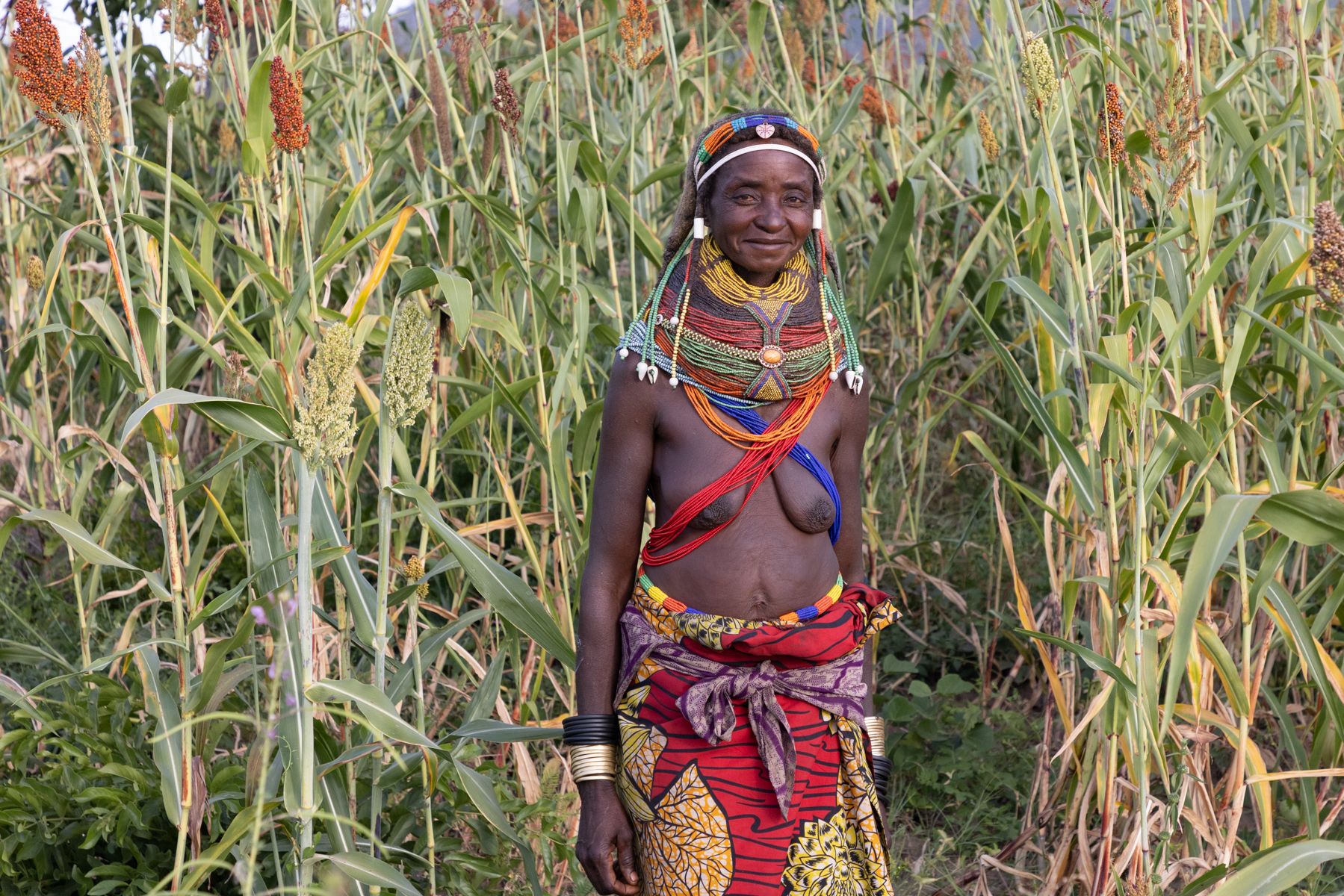 Portrait of a Ovamwila woman in her field of millet